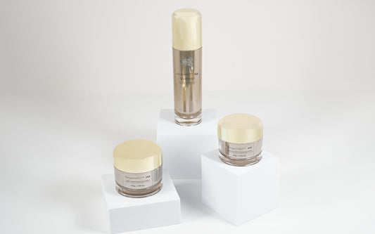 Image showcasing the Regen4D® Ultimate Hydration Trio: Hyaluronic Acid serum, face cream, and eye cream arranged atop geometric cubes of varying height.